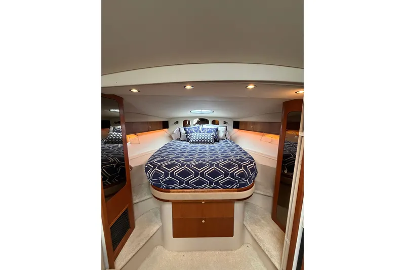 Slide: The Image of Luxurious cabin interior of 2001 Cruisers Yachts 3870 Express with patterned bedding. - 23