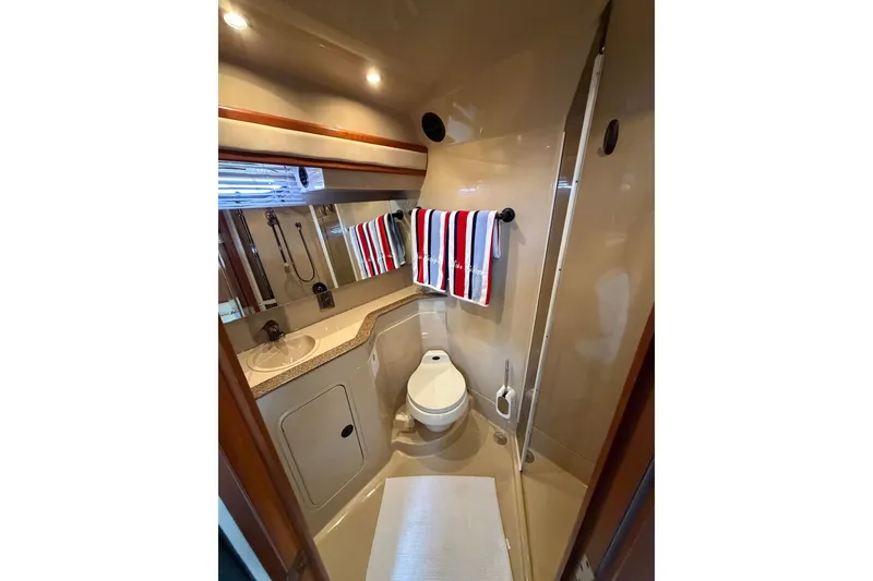 Slide: The Image of Luxurious bathroom in 2001 Cruisers Yachts 3870 Express with modern fixtures and striped towel. - 28