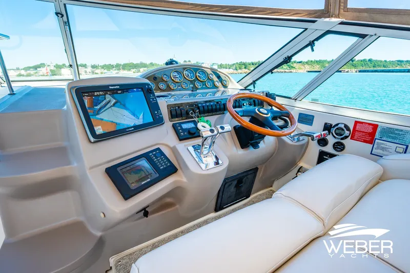 Slide: The Image of Helm of 2001 Cruisers Yachts 3870 Express with navigation equipment and wooden steering wheel. - 26