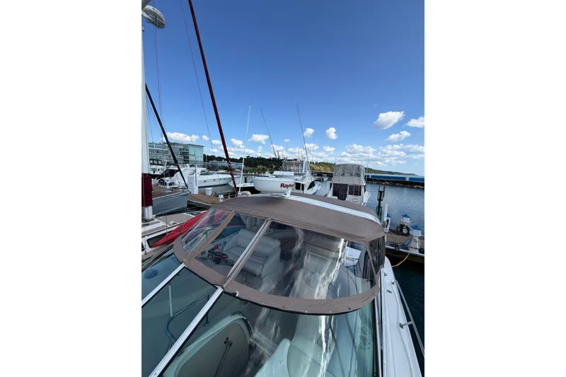 Slide: The Image of 2001 Cruisers Yachts 3870 Express docked at marina under clear blue sky. - 5