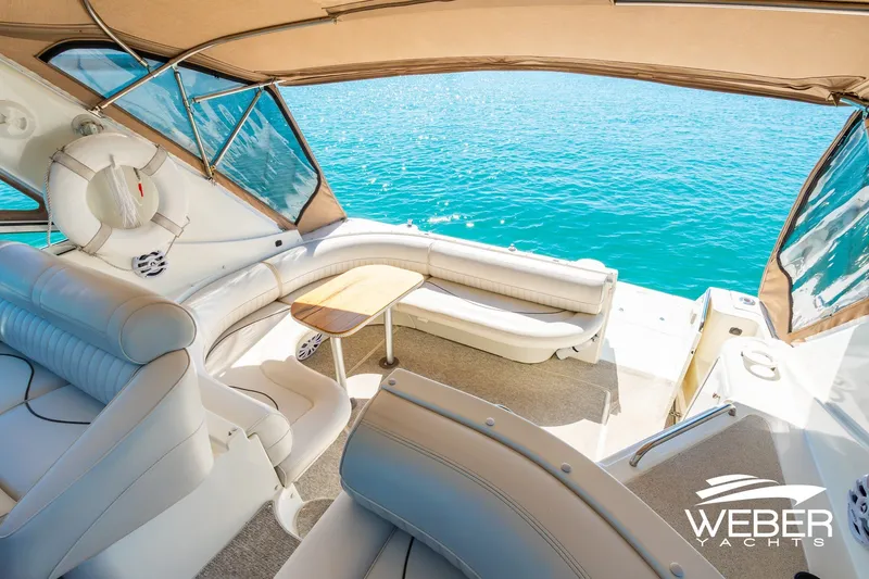 Slide: The Image of Luxurious 2001 Cruisers Yachts 3870 Express interior with plush seating and ocean view. - 21