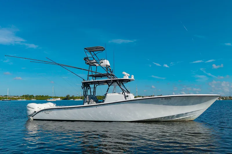 Slide: The Image of A 2015 Yellowfin 39 Offshore boat on calm water with a clear sky in the background. - 38
