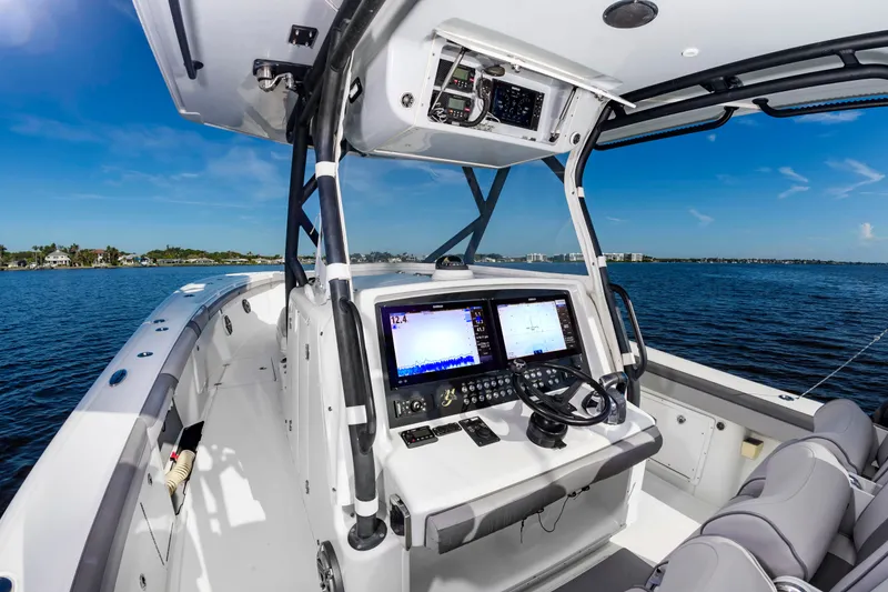 Slide: The Image of The image shows the cockpit of a 2015 Yellowfin 39 Offshore boat with modern electronics. - 14