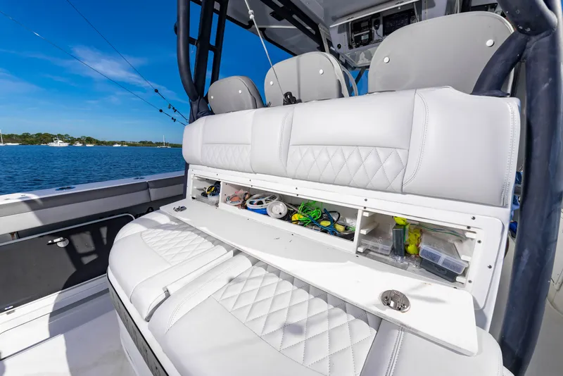 Slide: The Image of The image shows the cockpit of a 2015 Yellowfin 39 Offshore with white cushioned seats and storage. - 35