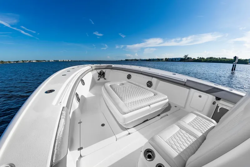 Slide: The Image of The image shows the bow of a 2015 Yellowfin 39 Offshore boat on calm water. - 10