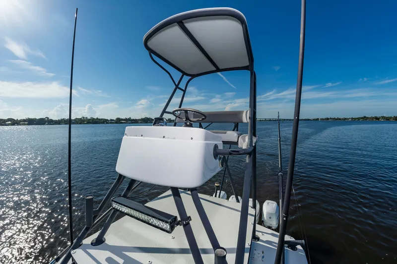 Slide: The Image of The image shows the helm of a 2015 Yellowfin 39 Offshore on calm water. - 23