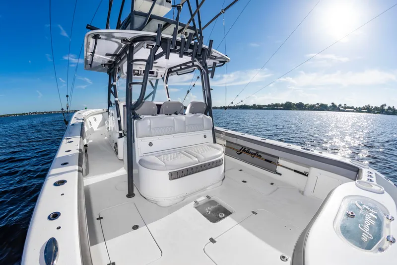 Slide: The Image of A 2015 Yellowfin 39 Offshore boat on the water. It features a spacious deck and fishing rod holders. - 29