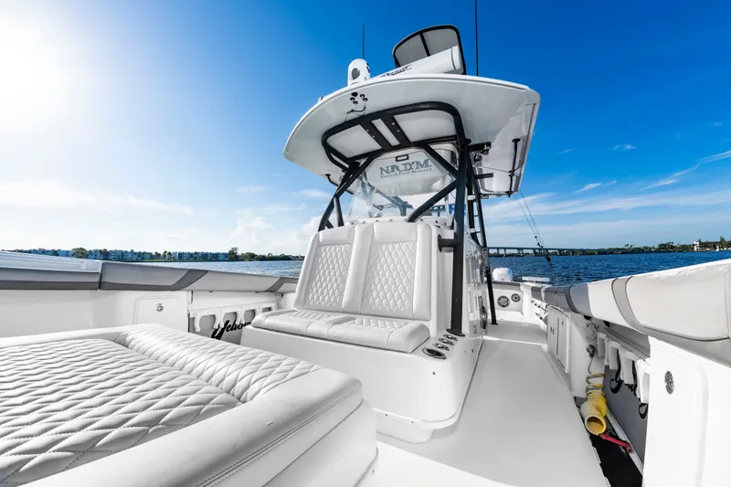 Slide: The Image of The image shows a 2015 Yellowfin 39 Offshore boat with luxurious white upholstery and a clear blue sky. - 12