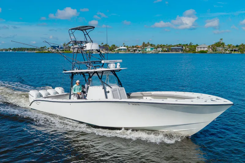 The Image of 2015 Yellowfin 39 Offshore on the water with blue sky and shoreline in the background. - 0