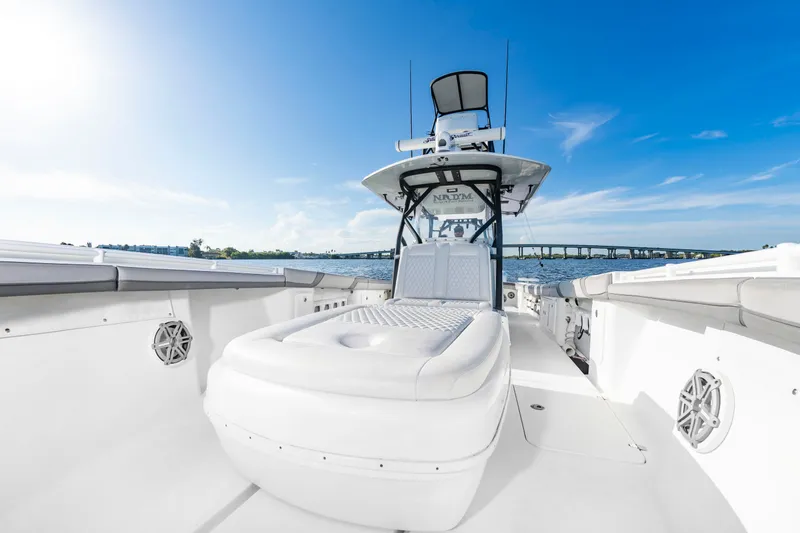 Slide: The Image of The image shows a 2015 Yellowfin 39 Offshore boat with a spacious deck and helm station. - 11
