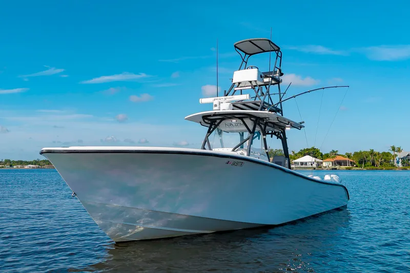 Slide: The Image of A 2015 Yellowfin 39 Offshore boat on calm water with a clear sky in the background. - 3