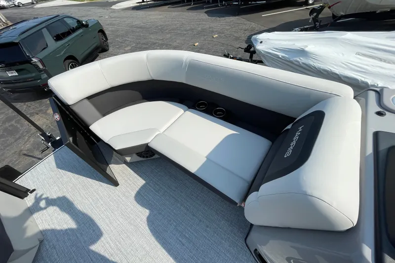 Slide: The Image of 2026 Harris Cruiser 210 SLDH boat interior with plush seating and cup holders. - 12