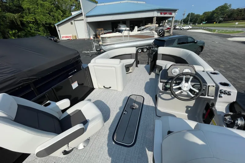 Slide: The Image of 2026 Harris Cruiser 210 SLDH pontoon boat interior with modern seating and steering console. - 15