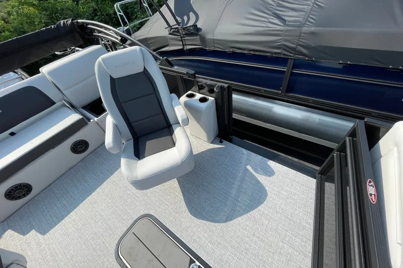 Slide: The Image of 2026 Harris Cruiser 210 SLDH boat interior with seating and cup holders. - 8