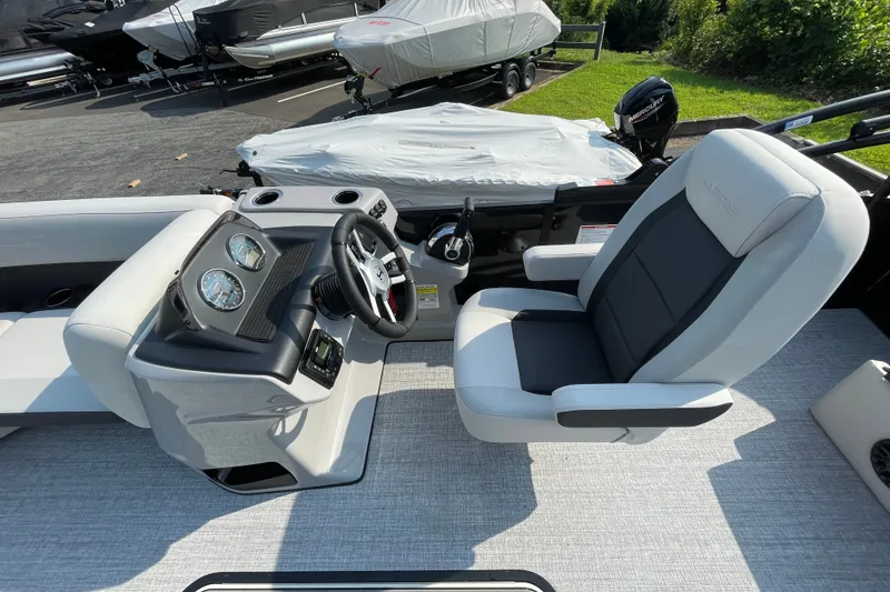 Slide: The Image of 2026 Harris Cruiser 210 SLDH boat interior with steering wheel and captain's chair. - 7