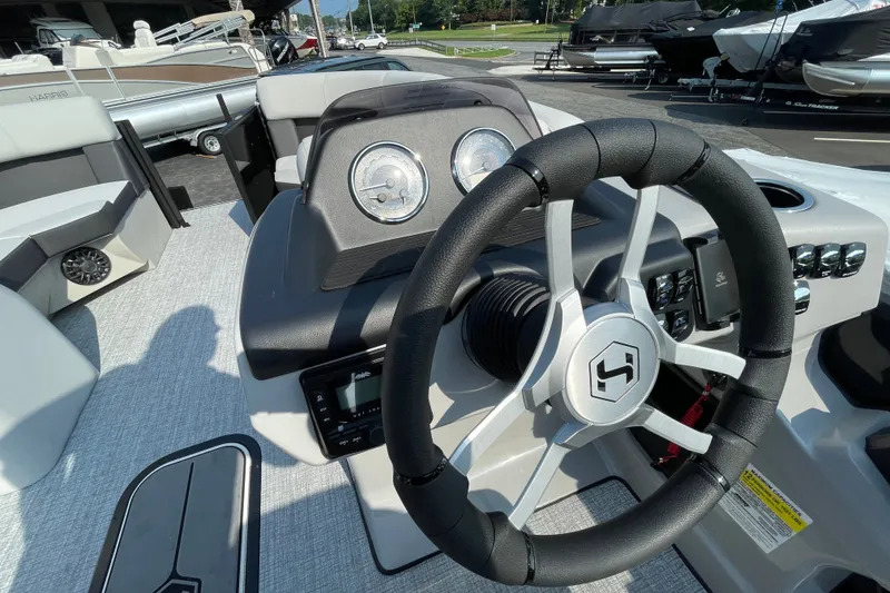 Slide: The Image of Steering console of 2026 Harris Cruiser 210 SLDH pontoon boat, featuring modern controls and gauges. - 14