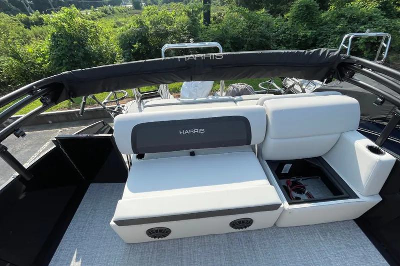 Slide: The Image of 2026 Harris Cruiser 210 SLDH boat interior with white seating and storage compartment. - 6
