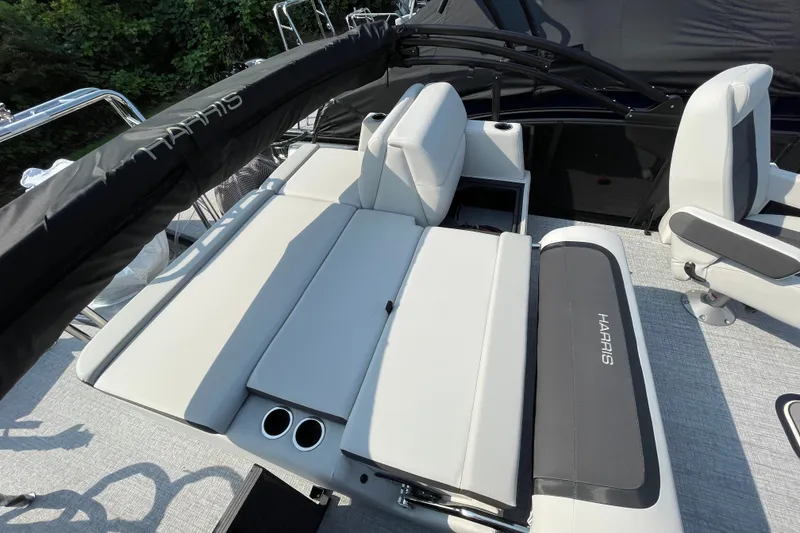 Slide: The Image of 2026 Harris Cruiser 210 SLDH boat interior with comfortable seating and cup holders. - 2