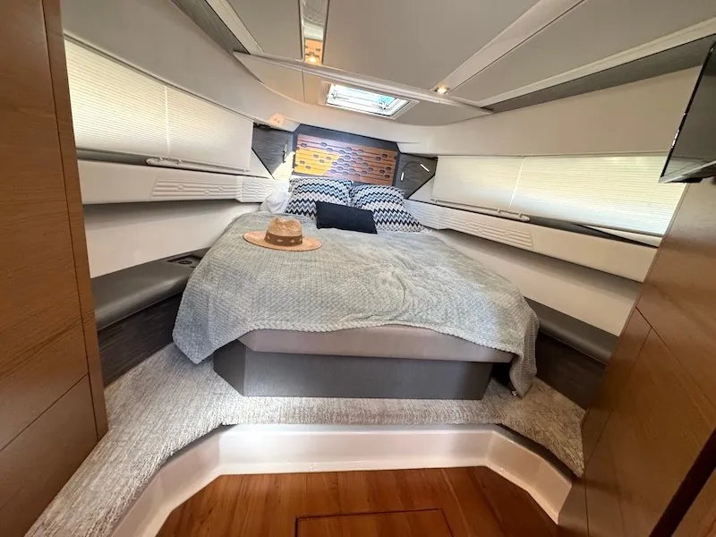 Slide: The Image of Cabin of the 2022 Tiara Yachts 43 LE with a cozy bed and skylights. - 25
