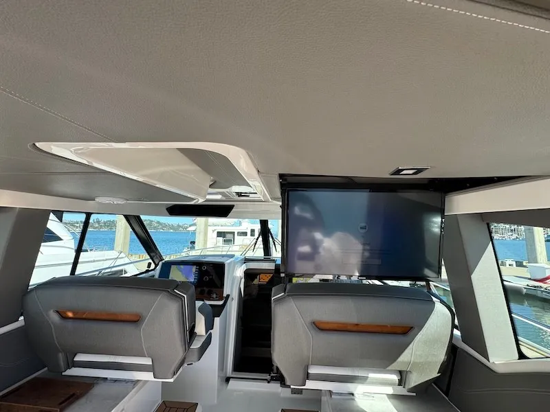 Slide: The Image of Interior of a 2022 Tiara Yachts 43 LE with modern seating and a large screen. - 47