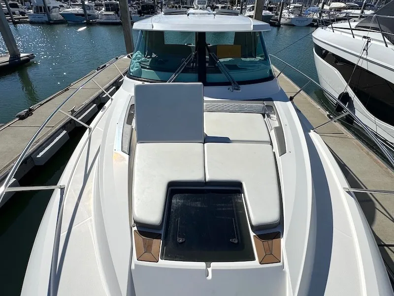 Slide: The Image of The 2022 Tiara Yachts 43 LE is docked, featuring a spacious foredeck with sun pads. - 10
