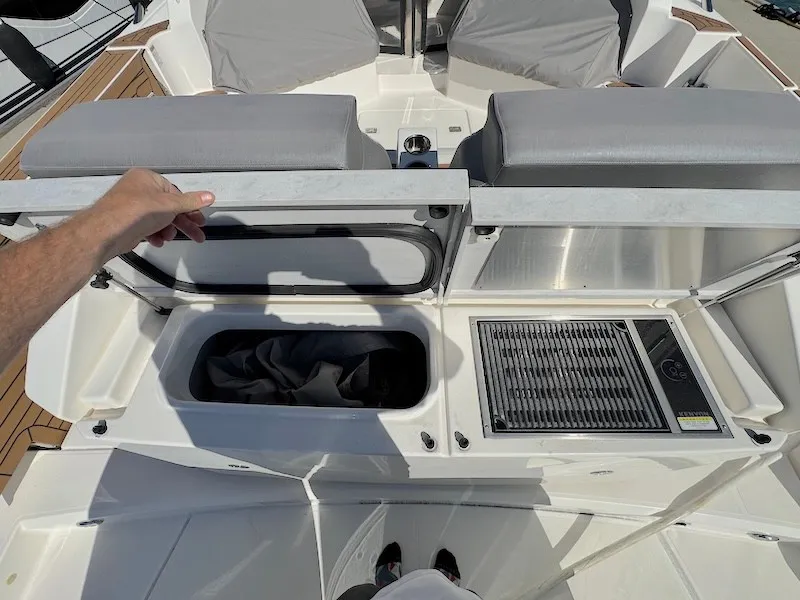 Slide: The Image of The image shows the deck of a 2022 Tiara Yachts 43 LE with storage and a grill. - 11