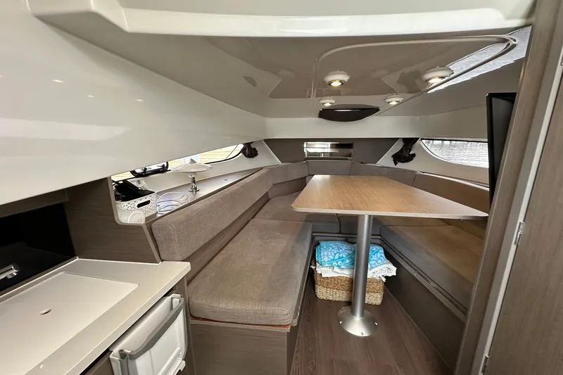 Slide: The Image of Interior of 2024 Beneteau Flyer 9 SUNdeck, featuring cozy seating and a wooden table. - 30