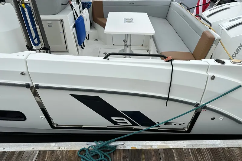 Slide: The Image of 2024 Beneteau Flyer 9 SUNdeck boat with seating and table, docked at marina. - 18