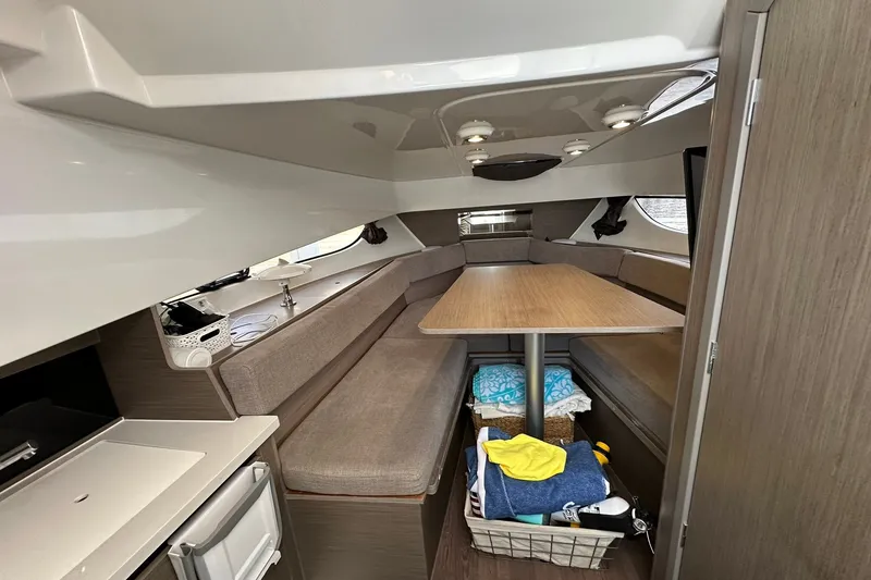 Slide: The Image of 2024 Beneteau Flyer 9 SUNdeck interior with seating, table, and storage basket. - 29