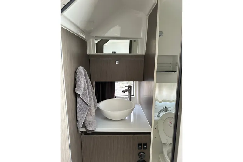Slide: The Image of Modern bathroom interior of 2024 Beneteau Flyer 9 SUNdeck boat, featuring sleek sink and cabinetry. - 28