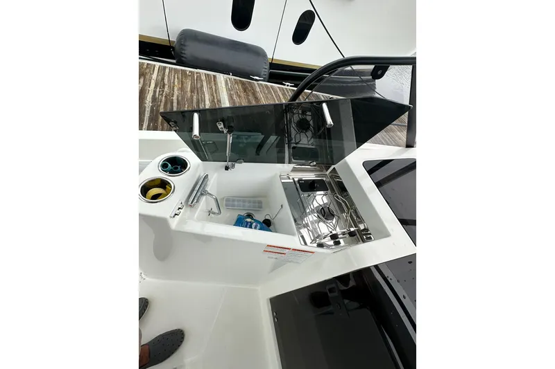 Slide: The Image of 2024 Beneteau Flyer 9 SUNdeck kitchenette with sink and stove, featuring modern design. - 17