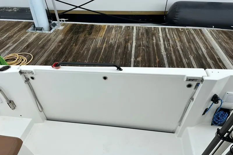 Slide: The Image of 2024 Beneteau Flyer 9 SUNdeck boat deck with wooden dock background. - 19