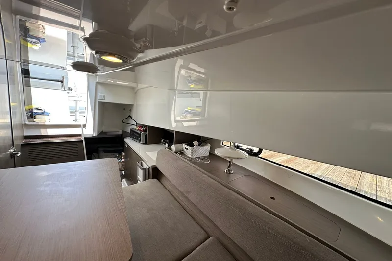 Slide: The Image of Interior of 2024 Beneteau Flyer 9 SUNdeck, featuring modern seating and compact kitchenette. - 34