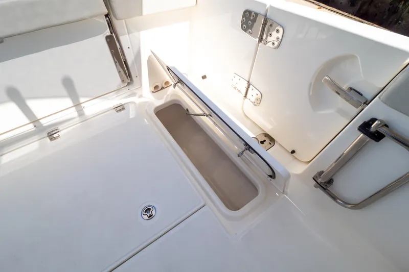 Slide: The Image of 2023 Boston Whaler 280 Vantage boat deck with open storage compartment. - 54