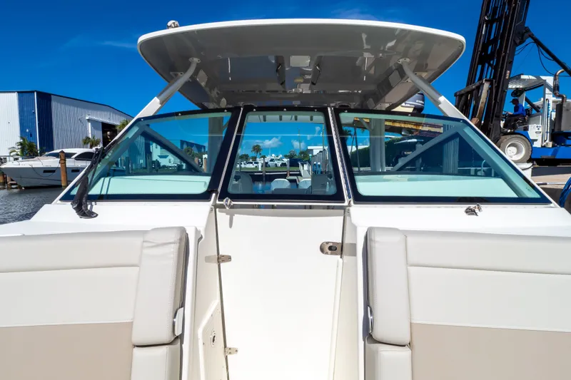 Slide: The Image of 2023 Boston Whaler 280 Vantage boat docked at marina under clear blue sky. - 87