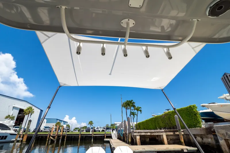 Slide: The Image of 2023 Boston Whaler 280 Vantage boat canopy at marina, clear blue sky background. - 41