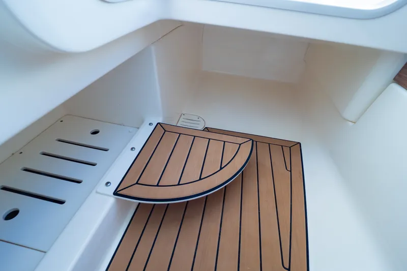 Slide: The Image of 2023 Boston Whaler 280 Vantage interior with teak flooring detail. - 86