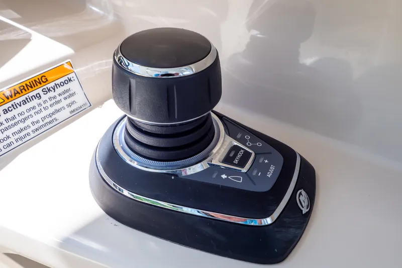 Slide: The Image of Joystick control on 2023 Boston Whaler 280 Vantage boat with Skyhook feature warning. - 14