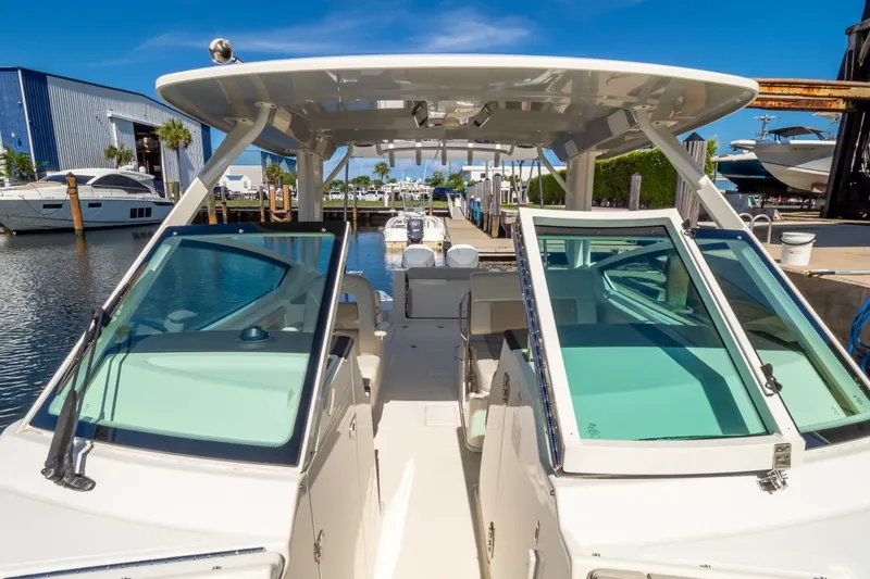 Slide: The Image of 2023 Boston Whaler 280 Vantage boat docked at marina under clear blue sky. - 81