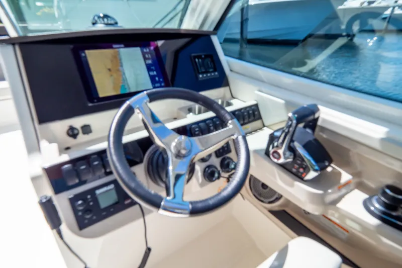 Slide: The Image of Cockpit of 2023 Boston Whaler 280 Vantage with navigation display and controls. - 102