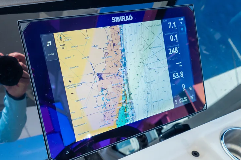Slide: The Image of Simrad navigation display on 2023 Boston Whaler 280 Vantage boat, showing detailed marine map. - 17