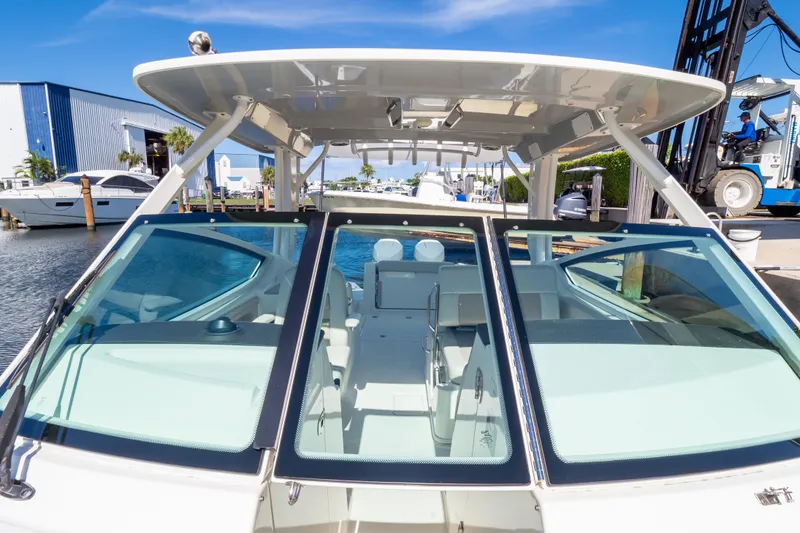 Slide: The Image of 2023 Boston Whaler 280 Vantage boat docked at marina under clear blue sky. - 22