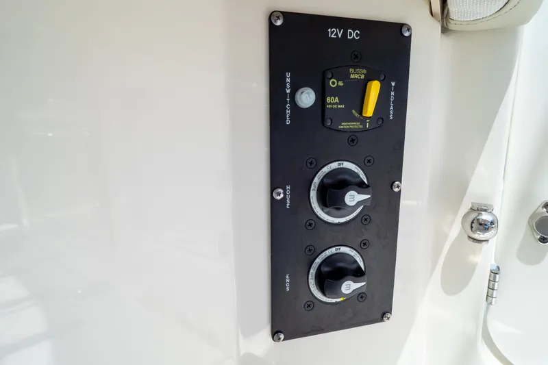 Slide: The Image of Control panel on 2023 Boston Whaler 280 Vantage boat, featuring 12V DC switches. - 43