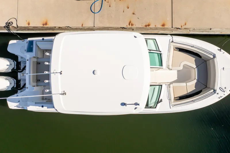 Slide: The Image of Top view of 2023 Boston Whaler 280 Vantage docked, showcasing spacious seating and dual engines. - 31