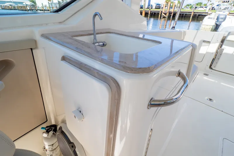 Slide: The Image of 2023 Boston Whaler 280 Vantage boat interior with sink and countertop detail. - 65