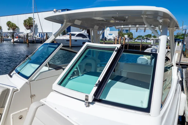Slide: The Image of 2023 Boston Whaler 280 Vantage boat docked at marina under clear blue sky. - 76