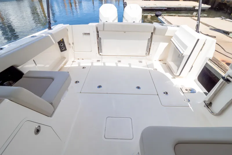 Slide: The Image of 2023 Boston Whaler 280 Vantage boat deck with seating and storage compartments. - 44