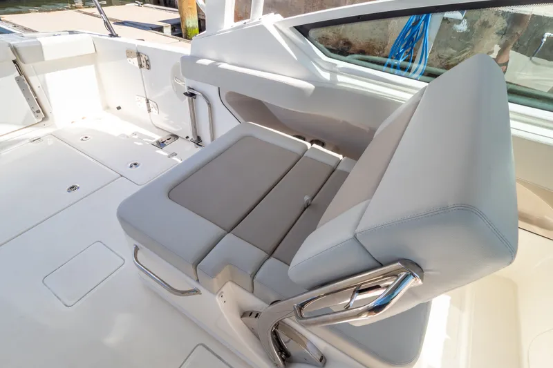Slide: The Image of 2023 Boston Whaler 280 Vantage boat interior with gray seating and stainless steel accents. - 62