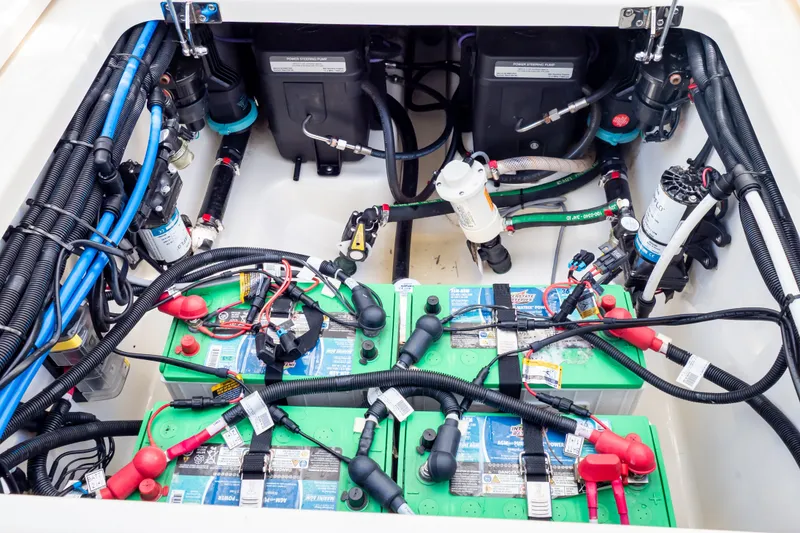 Slide: The Image of 2023 Boston Whaler 280 Vantage engine compartment with batteries and wiring. - 55
