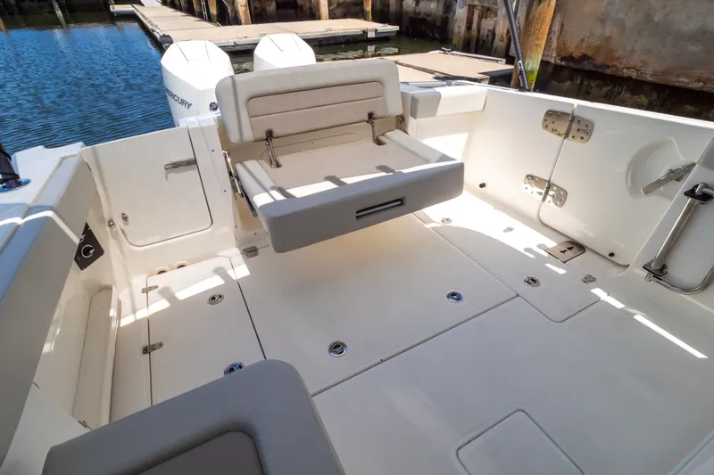 Slide: The Image of 2023 Boston Whaler 280 Vantage boat interior with foldable seating and spacious deck. - 51